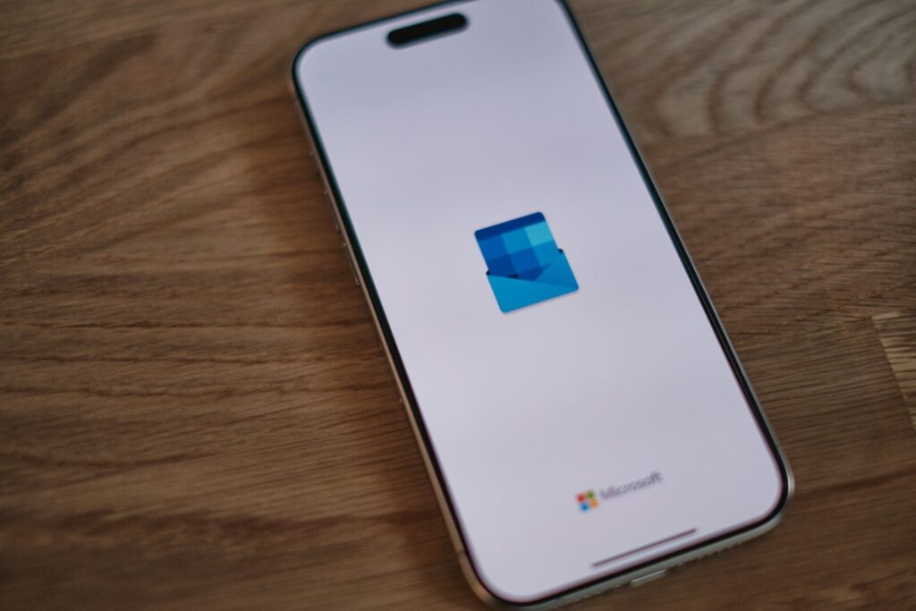 A white cell phone sitting on top of a wooden table